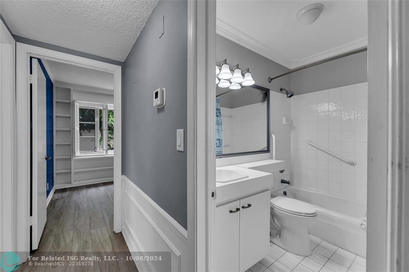 Full bath in with a bathtub.  View of hallway and into second bedroom.