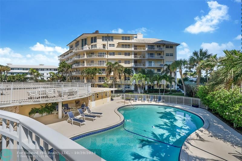 Pool area with lounge chairs and separate bathrooms with showers