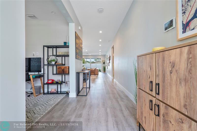 entry with view towards den, kitchen and open living room