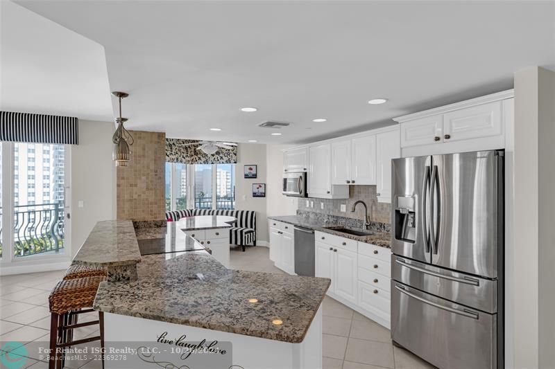 Open remodeled kitchen, granite counter tops, stainless steel appliances and views of the Intracoastal.