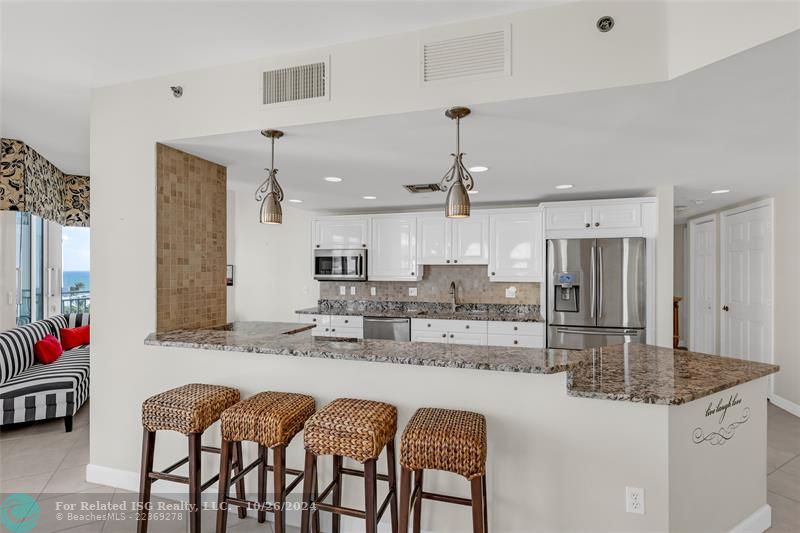 Open remodeled kitchen, granite counter tops, stainless steel appliances and views of the Intracoastal.