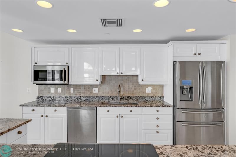 Open remodeled kitchen, granite counter tops, and stainless steel appliances.