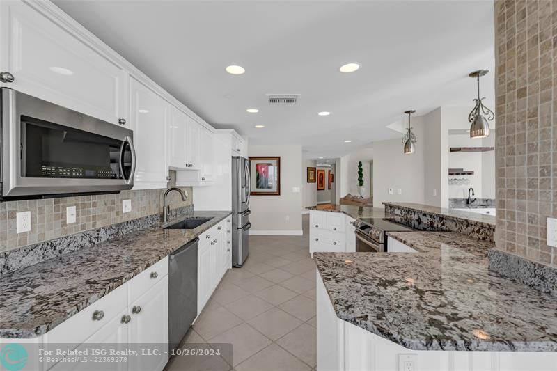 Open remodeled kitchen, granite counter tops, and stainless steel appliances.