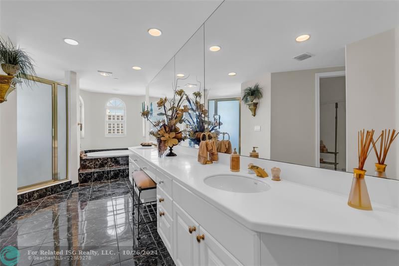 Luxurious bathroom with double sink vanity, soaking tub, separate shower, and bidet.