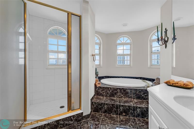 Luxurious bathroom with double sink vanity, soaking tub, separate shower, and bidet.