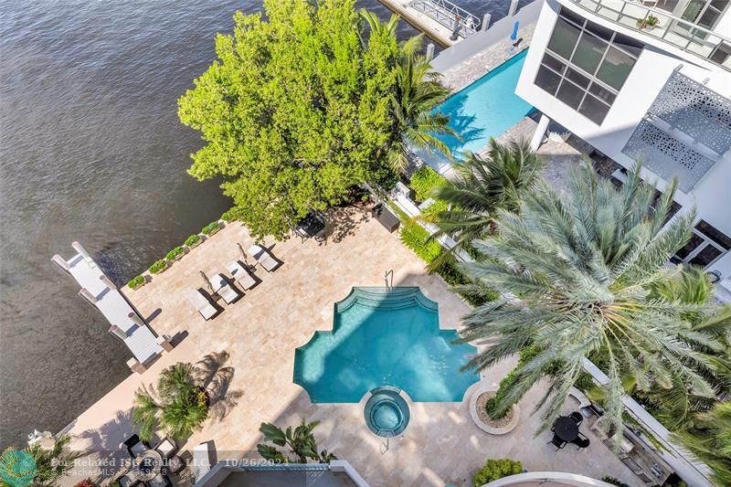 From the balcony an aerial view of the pool, hot tub and boat docks.