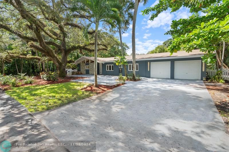 stunning tropical front w/ Oak tree and palms all around the house. fresh mulch and landscaping done.