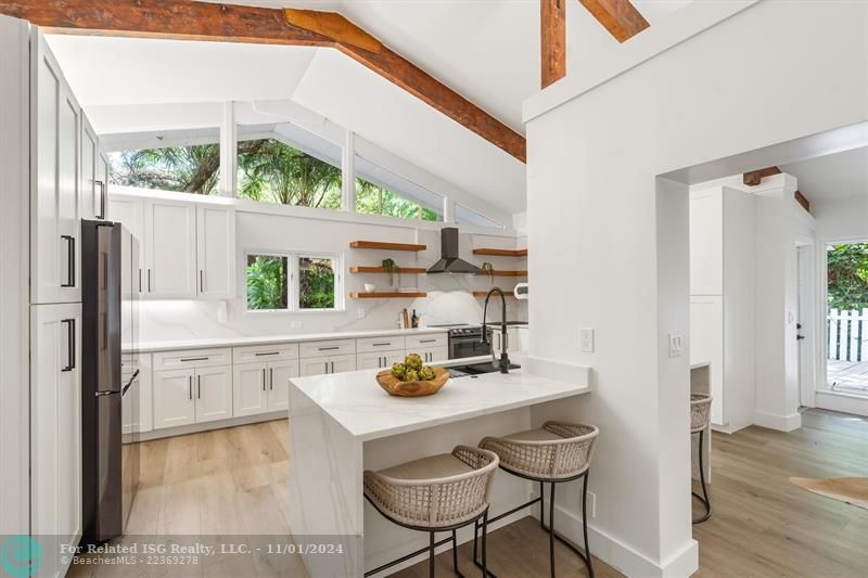 new kitchen with solid wood cabinets. quartz waterfall.