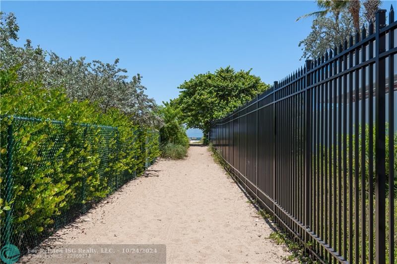 Walkway down to the beach where you are greeted by blue water and the jetties.