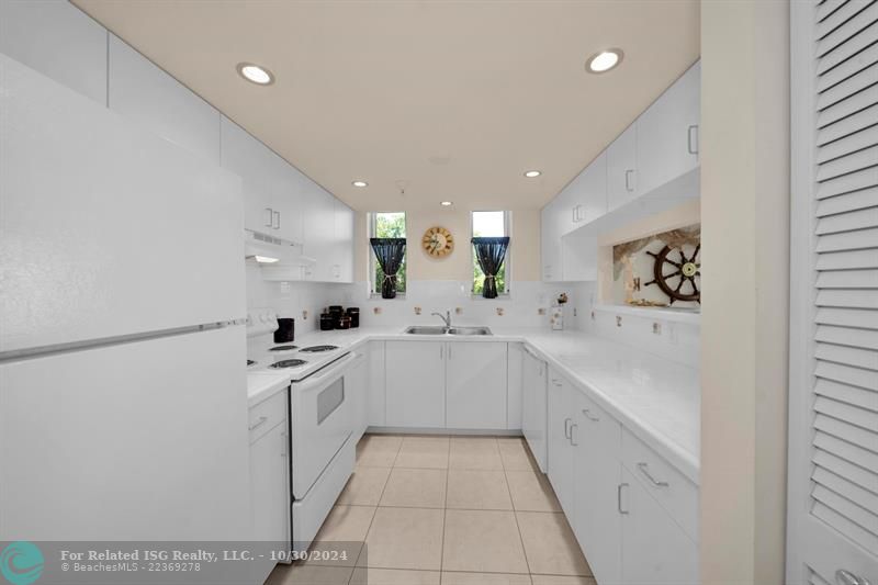 Bright spotless open Kitchen with views of the water.