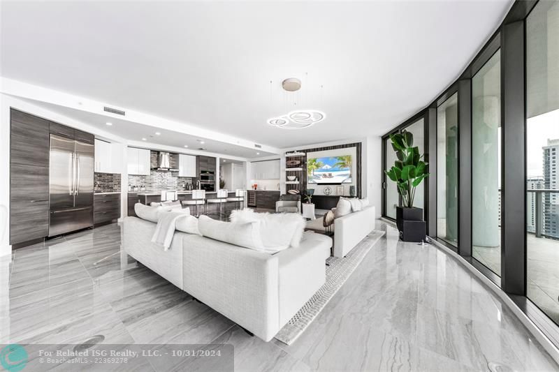 Open & expansive living area with model high-end furnishings & decor