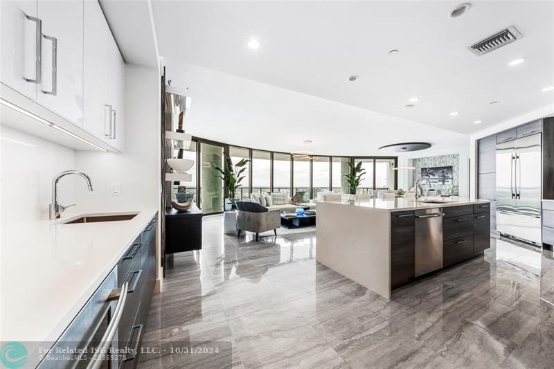 Gorgeous kitchen with Nolte cabinetry, lux backsplash, wet bar + wine fridge, tons of storage, large waterfall island & amazing views!