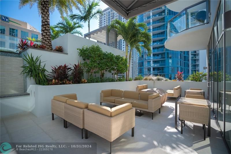 Outdoor lounge area by the rooftop pool with grills & water feature that flows into indoor space for great entertaining options!