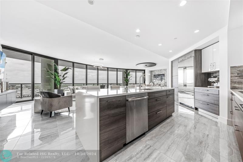 Gorgeous kitchen with Nolte cabinetry, lux backsplash, wet bar + wine fridge, tons of storage, large waterfall island & amazing views!