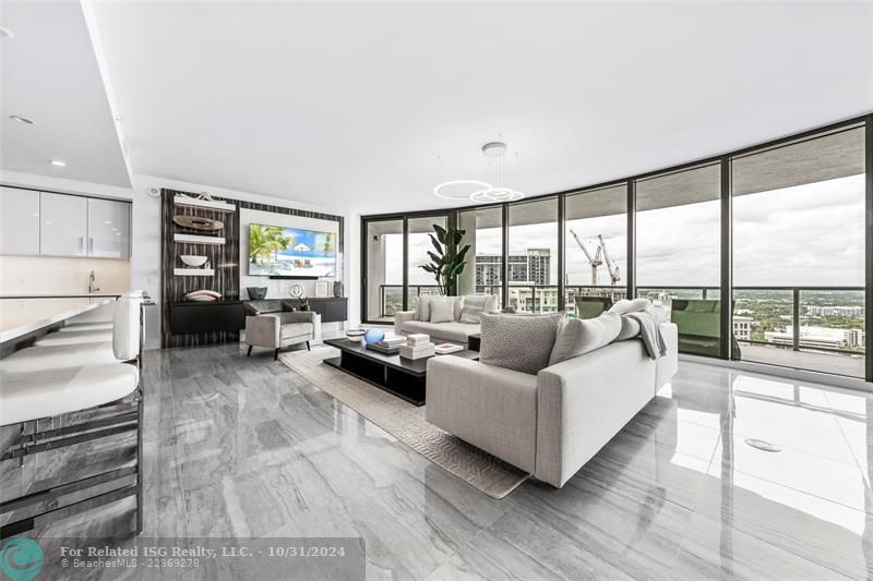 Open & expansive living area with model high-end furnishings & decor