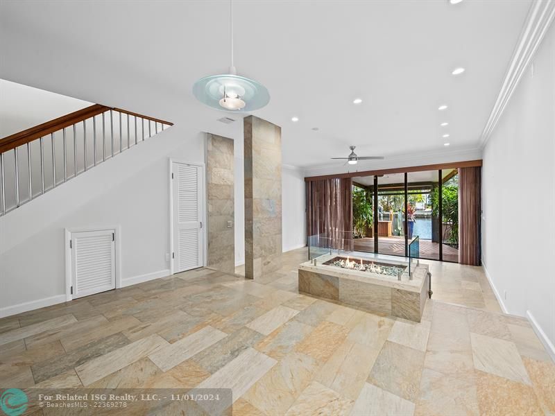 Dining room with beautiful fireplace looking through the living area to the beautiful waterfront