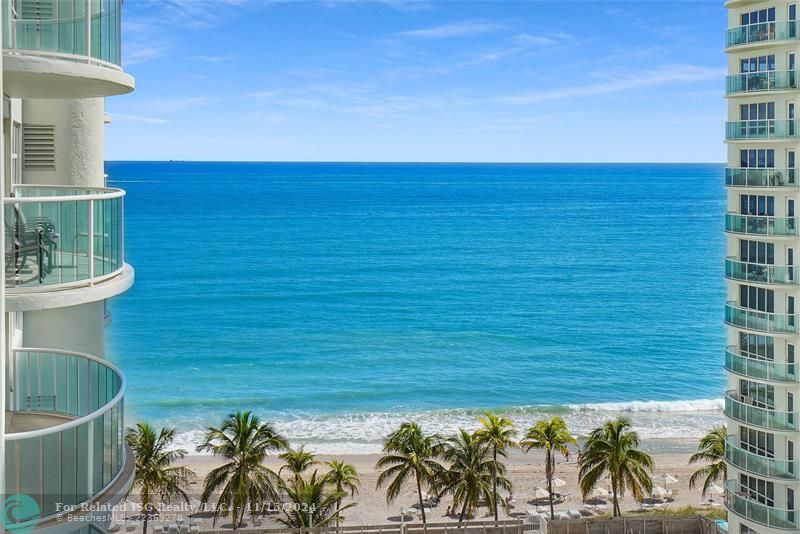 A close up view from the balcony. In this picture, you can see our new beach umbrellas, umbrella tables and beach chairs which are available to owners.