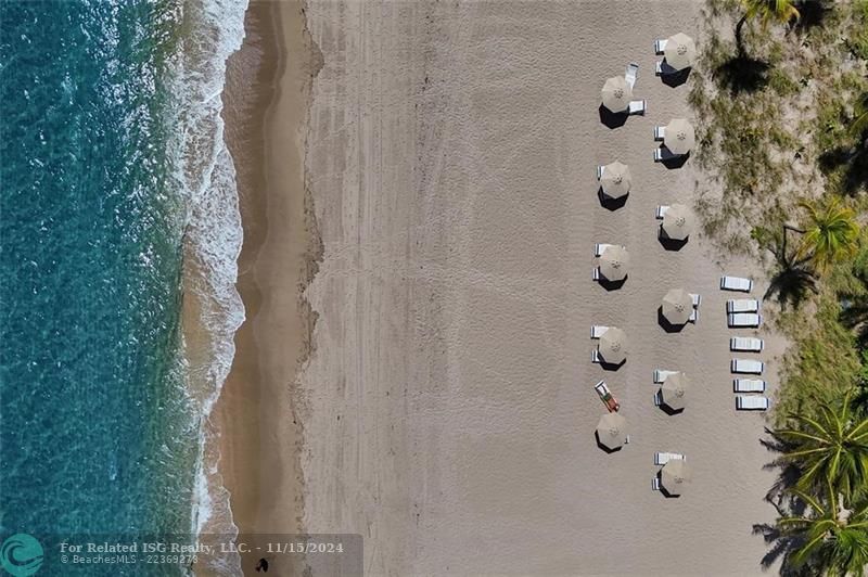 An aerial view from another apartment of our beach umbrellas and chairs.