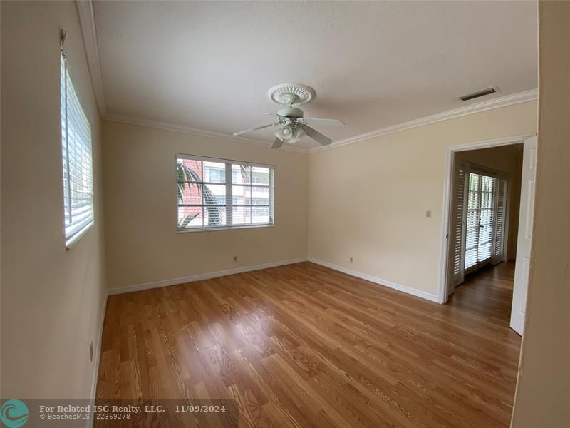 Living room with French doors opened to the balcony.