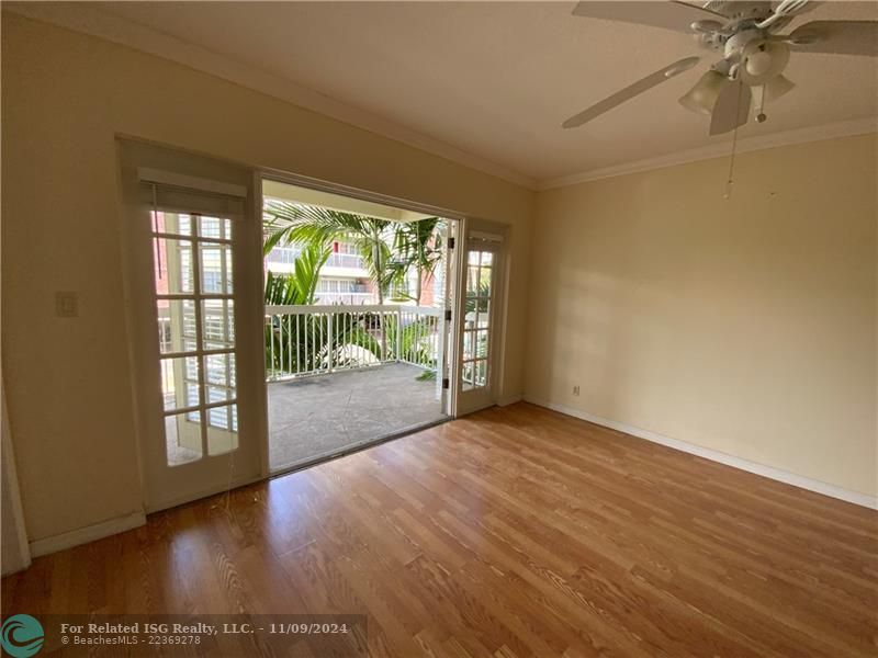 Living room with French doors opened to the balcony.