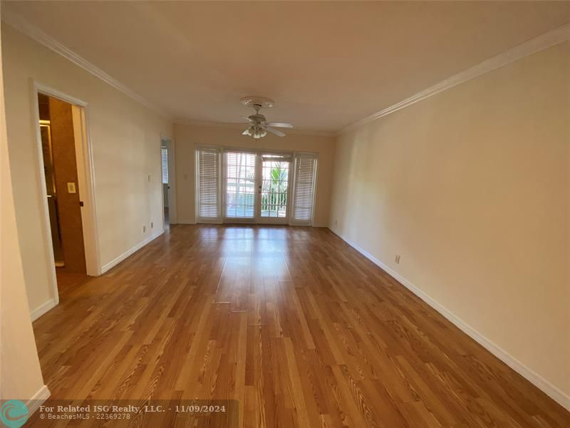 Living room with French doors opened to the balcony.