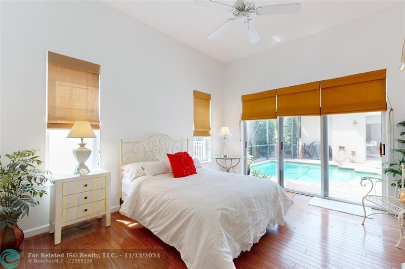 Primary bedroom room with pool views