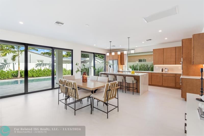 Spacious dining / kitchen area with sliders out to covered patio and pool.