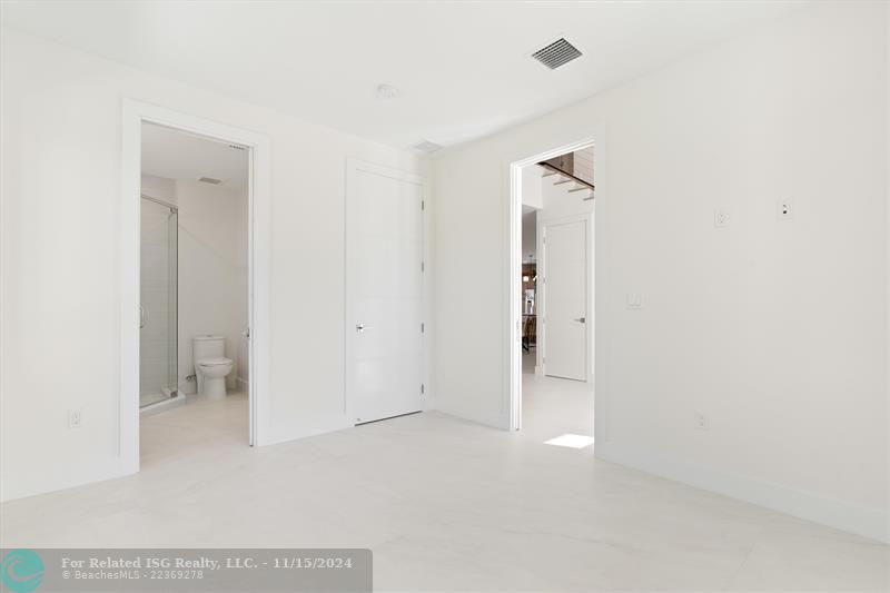 Main floor 4th bedroom with entry way to foyer  and guest bathroom