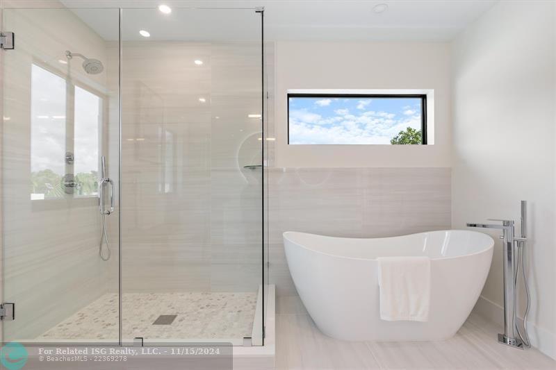 Primary bath with generous shower and soaking tub