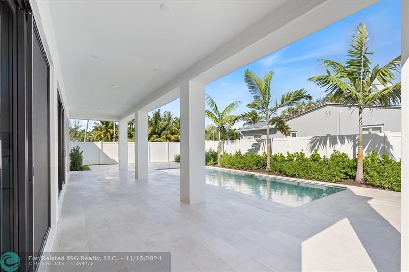 West view of expansive covered patio and pool deck