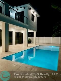 Night view of pool and deck area.