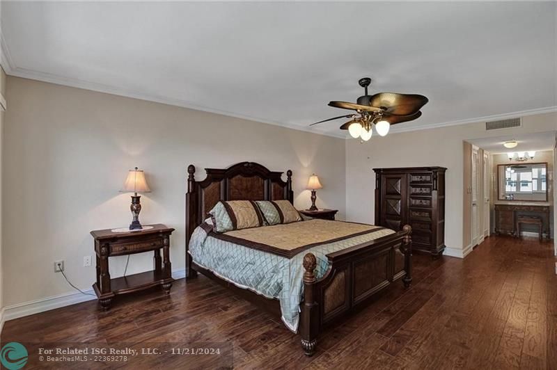 The two doors on the left after the bureau lead to two walk in closets. Across from those walk in closets there is a linen closet. You can see the entrance to the en suite primary bathroom.