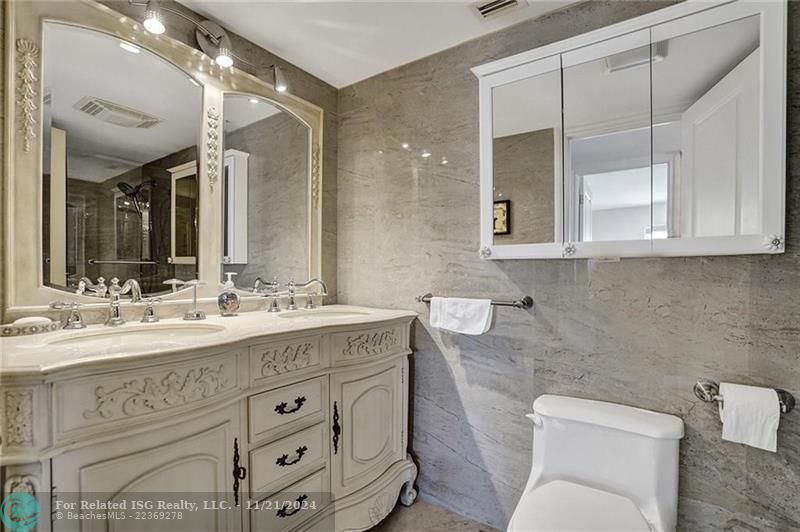 The second bathroom has a granite topped vanity and double sinks. It is right across from the second bedroom.