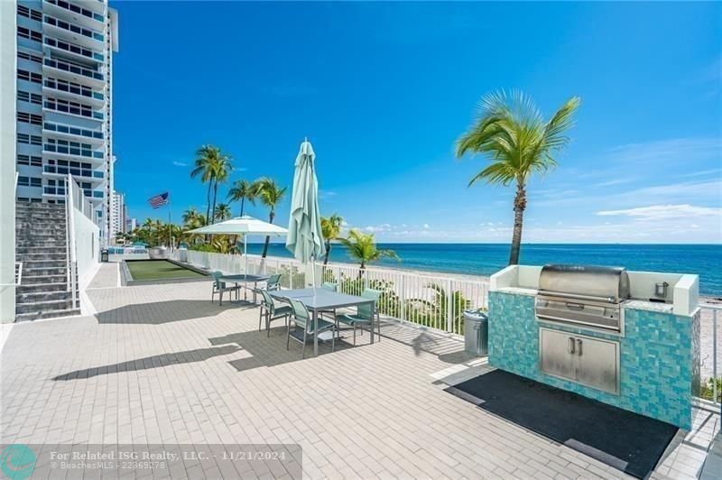 The lower beach deck runs the length of the 2 towers. The 2 bbq's, the bocce court and the stairs leading up to the tennis court are here.