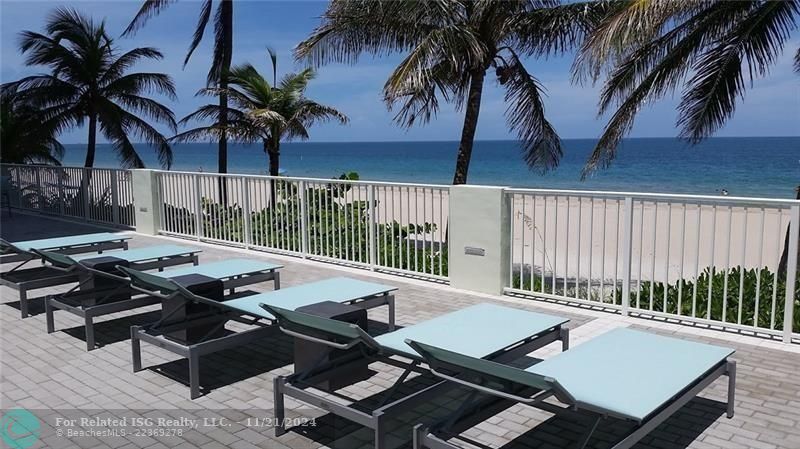 The lower beach deck facing north has lots of seating.