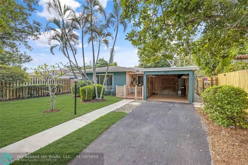 Front of home with enclosed carport.