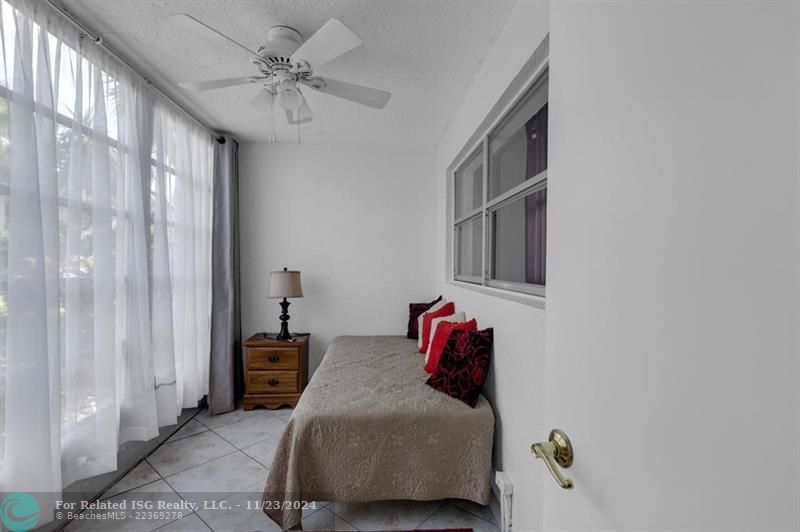 Balcony with windows, being used as a guest room