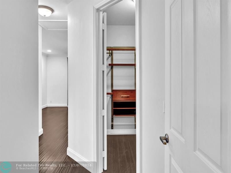 entrance to main bedroom with walk in on right and large bath on left