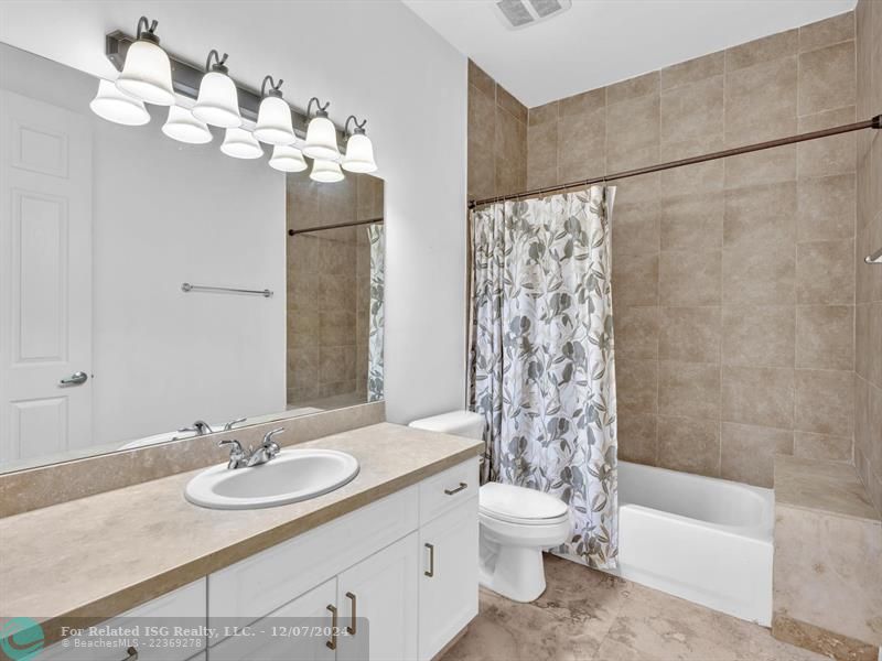 entrance to main bedroom with walk in on right and large bath on left