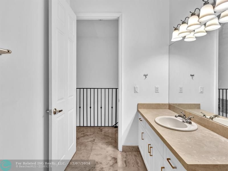 entrance to main bedroom with walk in on right and large bath on left