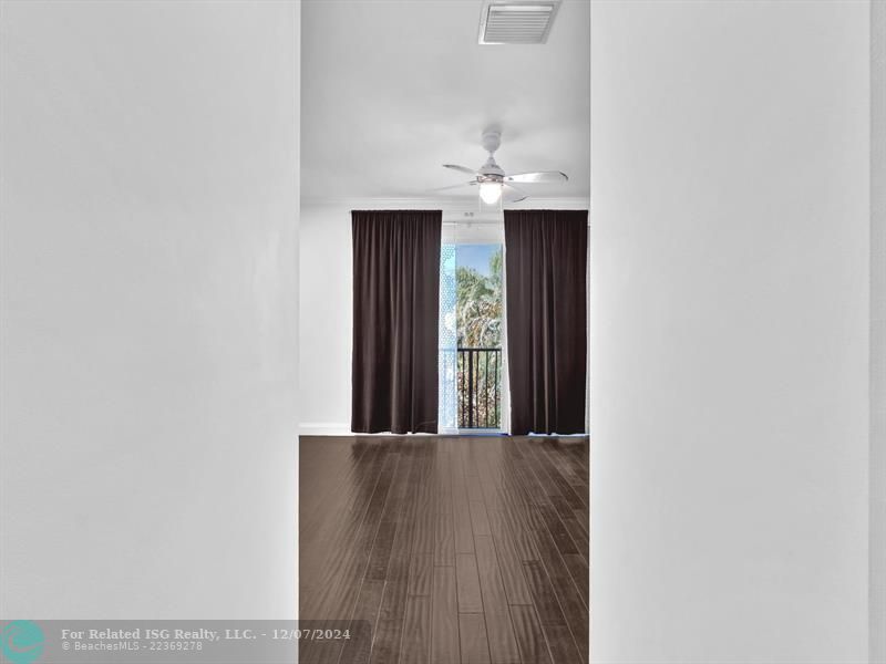 entrance to main bedroom with walk in on right and large bath on left