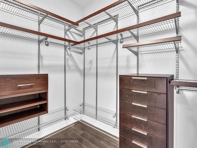 entrance to main bedroom with walk in on right and large bath on left