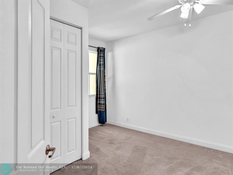 entrance to main bedroom with walk in on right and large bath on left