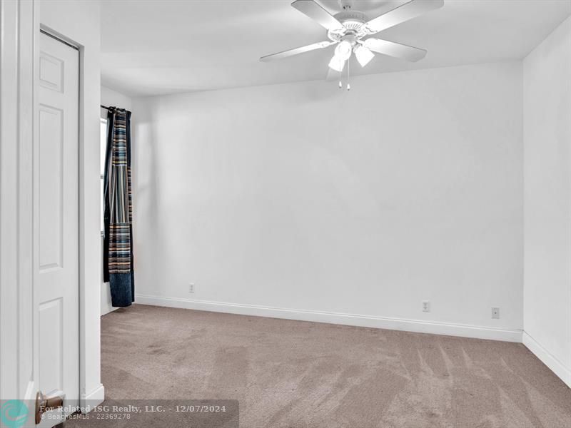 entrance to main bedroom with walk in on right and large bath on left