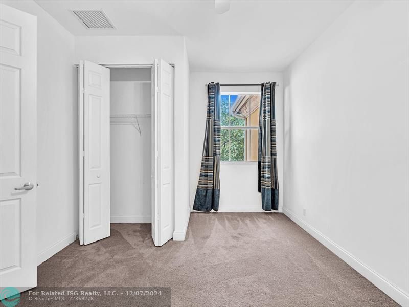 entrance to main bedroom with walk in on right and large bath on left