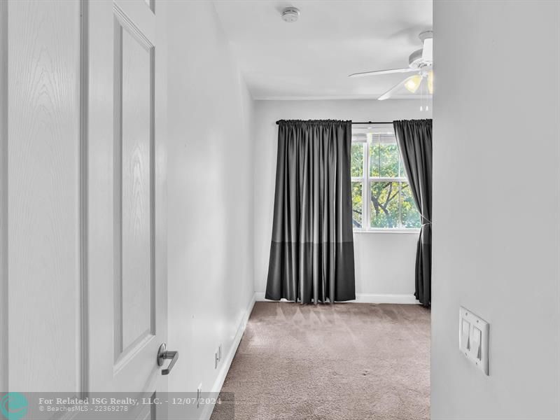 entrance to main bedroom with walk in on right and large bath on left