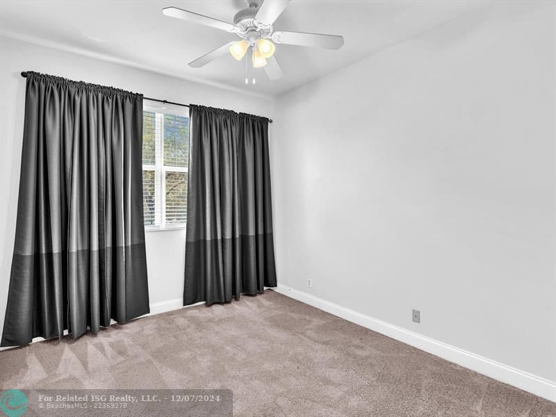 entrance to main bedroom with walk in on right and large bath on left