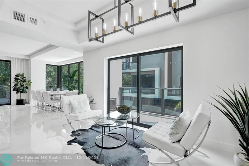 Corner townhouse-condo with floor-to-ceiling windows.