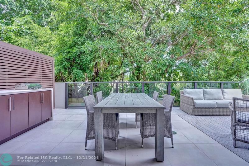 Corner townhouse-condo with floor-to-ceiling windows.