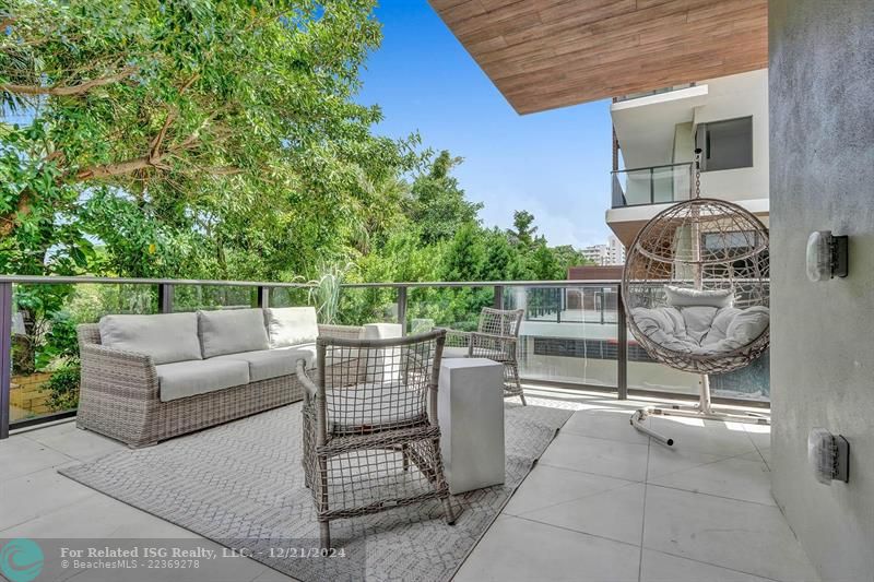 Corner townhouse-condo with floor-to-ceiling windows.